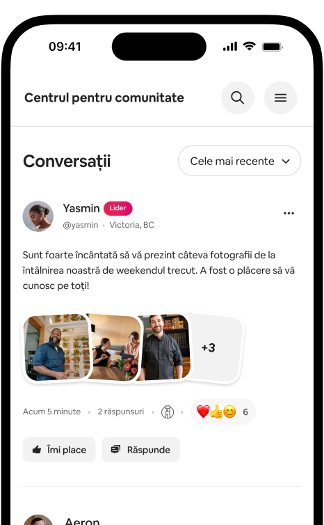 Telefon care afișează o filă de conversații cu o postare cu fotografie de la o gazdă și reacții din partea comunității.
