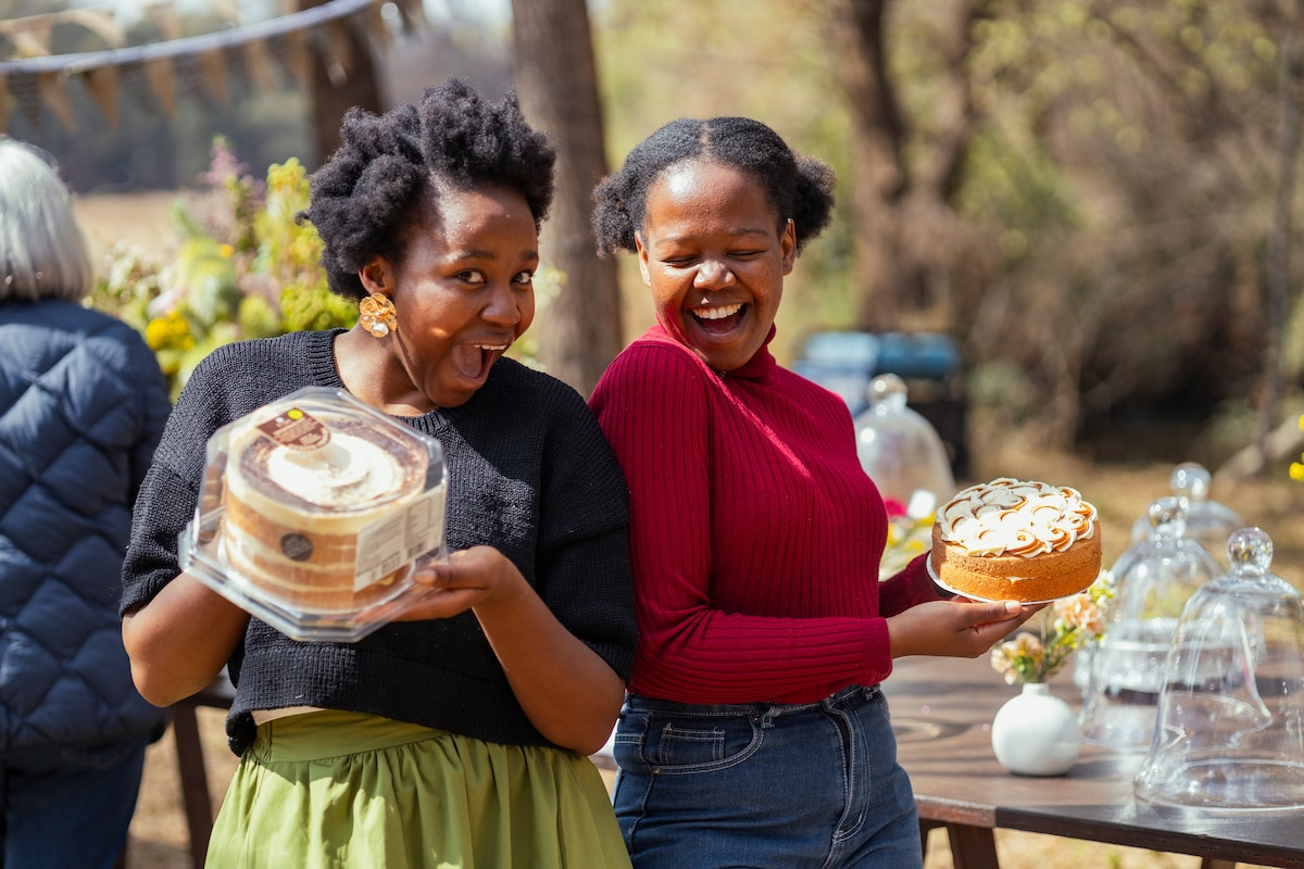 Two hosts laughing and sharing a moment at the Pretoria Host Community Meetup.