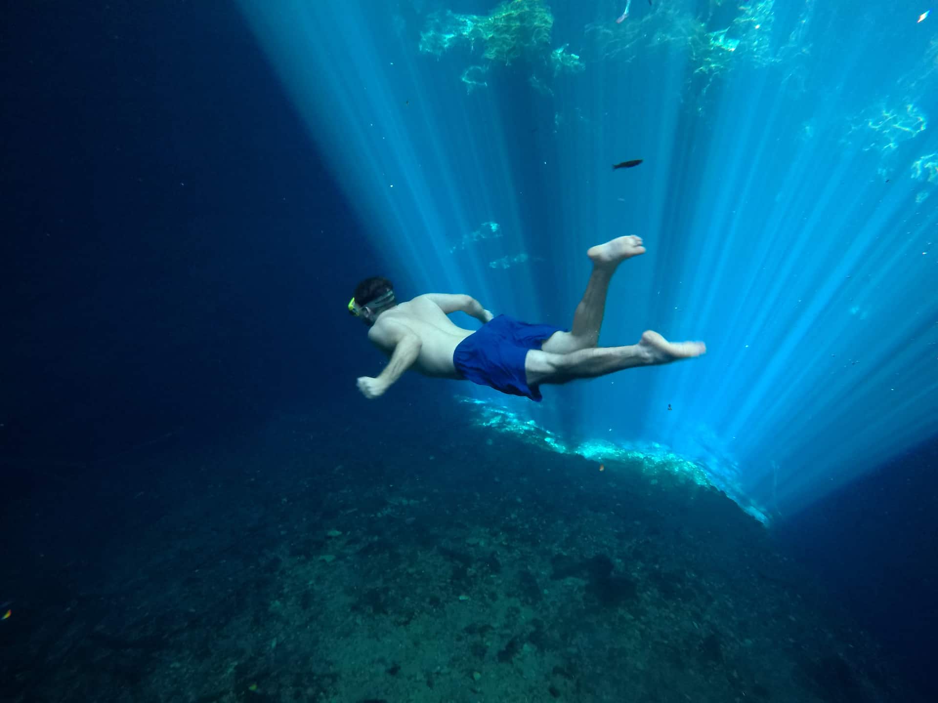 woman in the middle of circular platform in cenote suytun