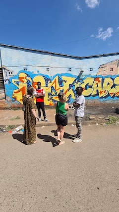 Admire Kibera's street art with local artists