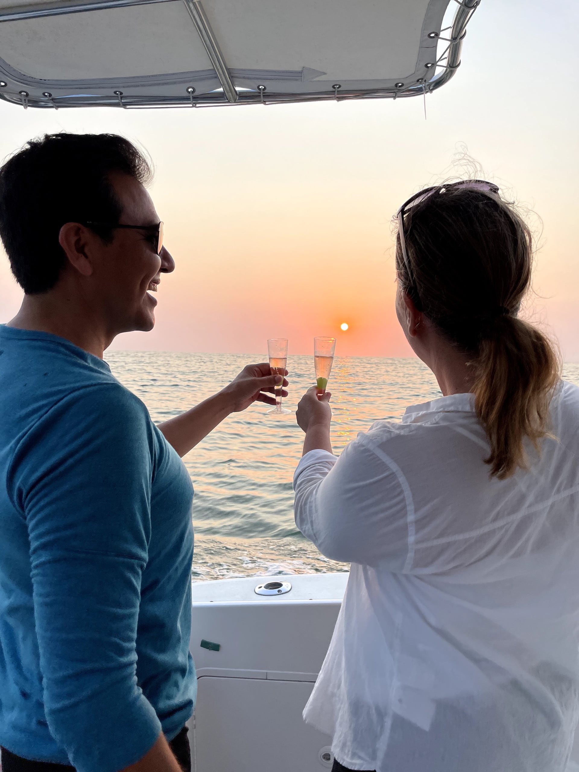 couple sitting at the edge of the yacht watching the sunset | Puerto Vallarta boat tours