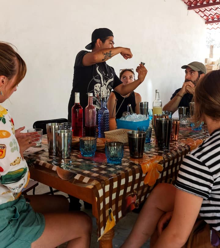 Makes cocktails with Mezcal and Oaxacan snacks