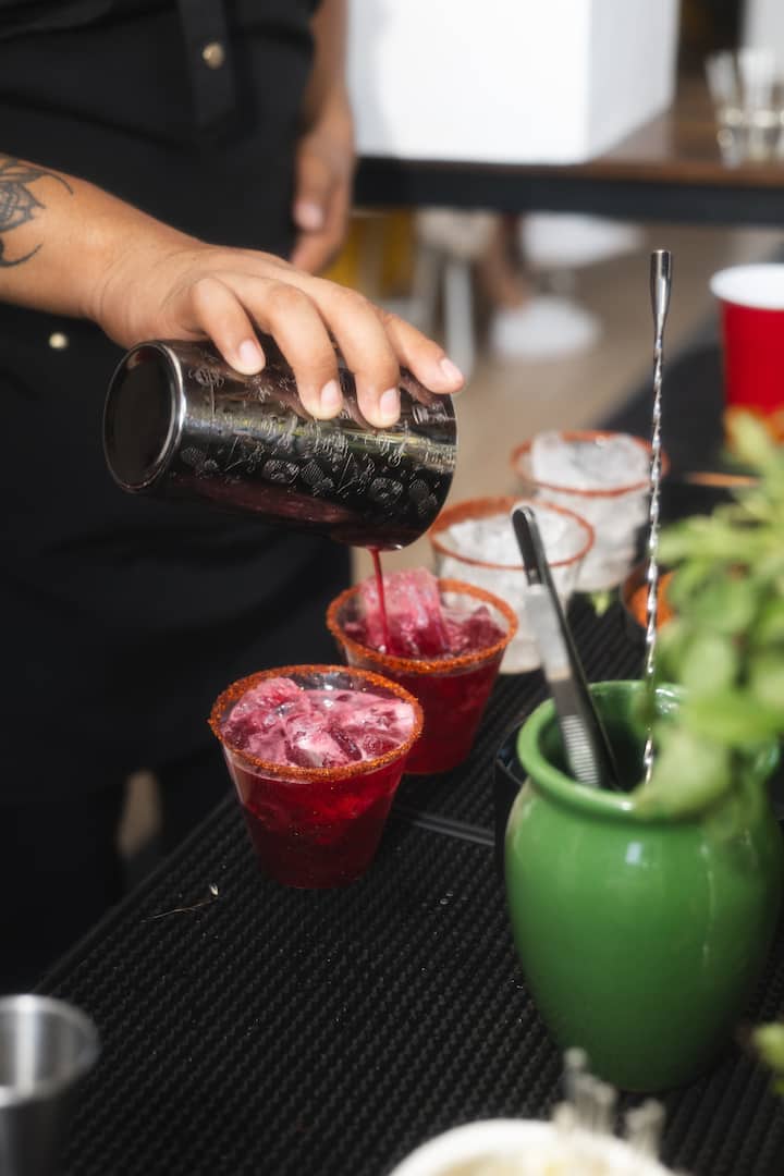 Makes cocktails with Mezcal and Oaxacan snacks