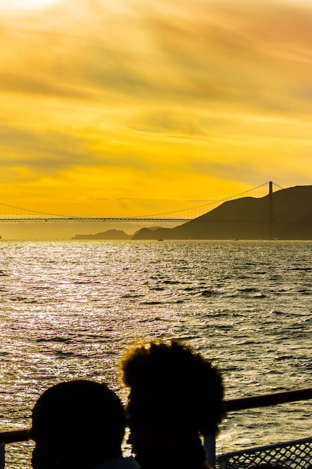 Sail into golden hour under the bridge