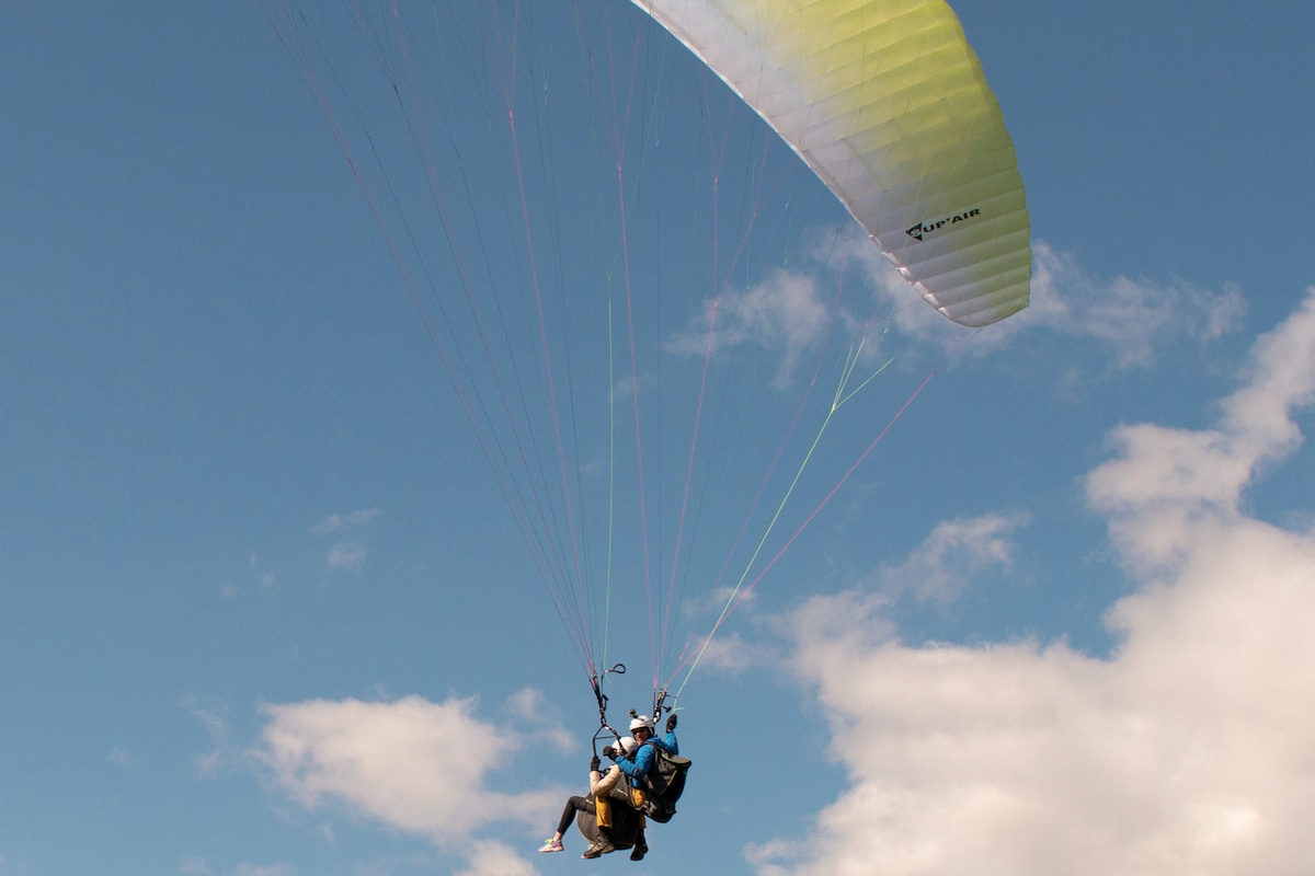 Tandem paragliding with a view of the glacier