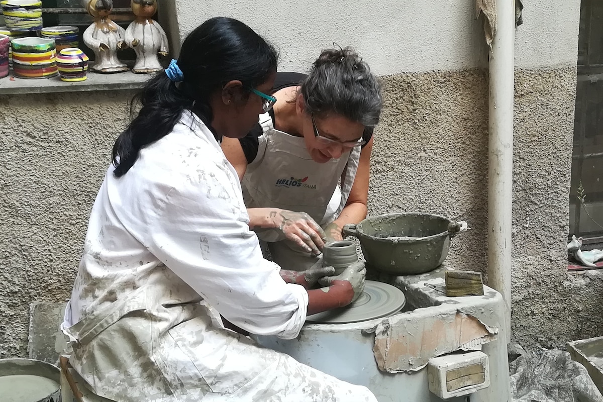Create traditional pottery with a ceramic artist