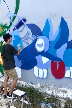 Create street art with a mural artist