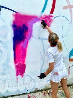 Create street art with a mural artist
