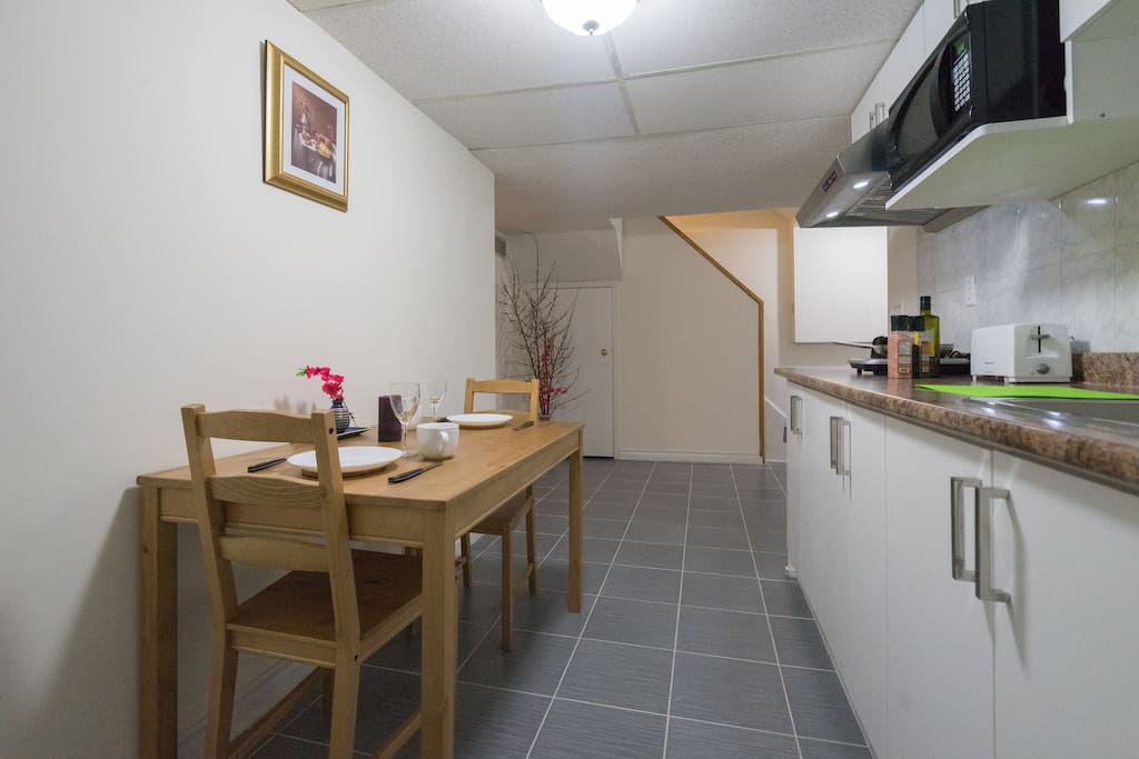 Kitchen area - NO STOVE, microwave oven and toaster, dinning table, fridge, plate, bowl, knife & fork