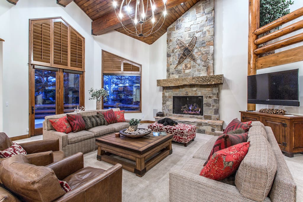 Great Room with vaulted ceiling and stone fireplace