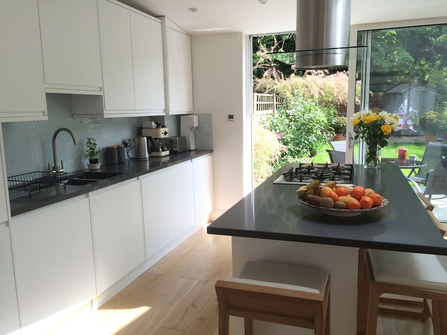 Glass doors provide garden backdrop to kitchen