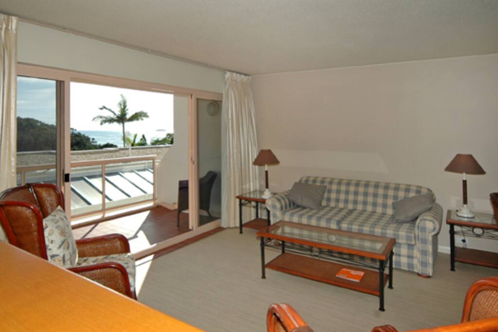 Lounge room facing north east with ocean views. Note, couch has been updated since this photo was taken.