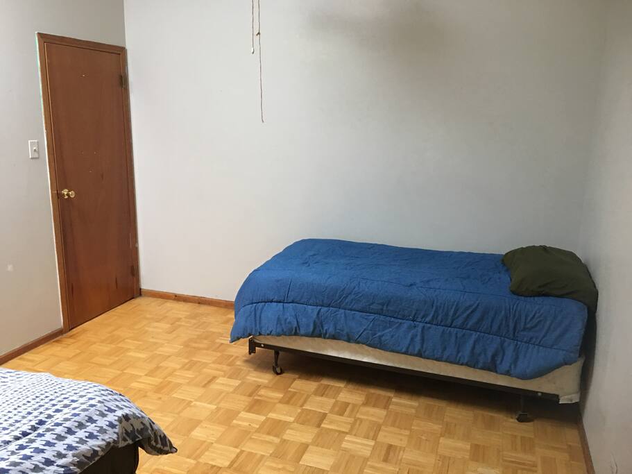 The twin bed that shares the space. This bed is booked separately and may be occupied by another guest.