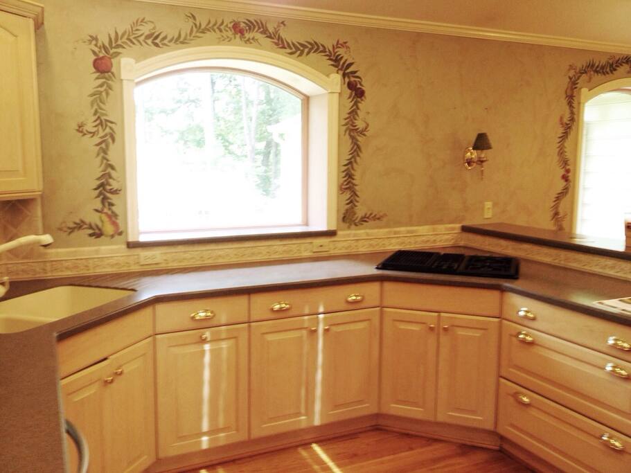 Luxury kitchen includes gas downdraft range with built-in grill.