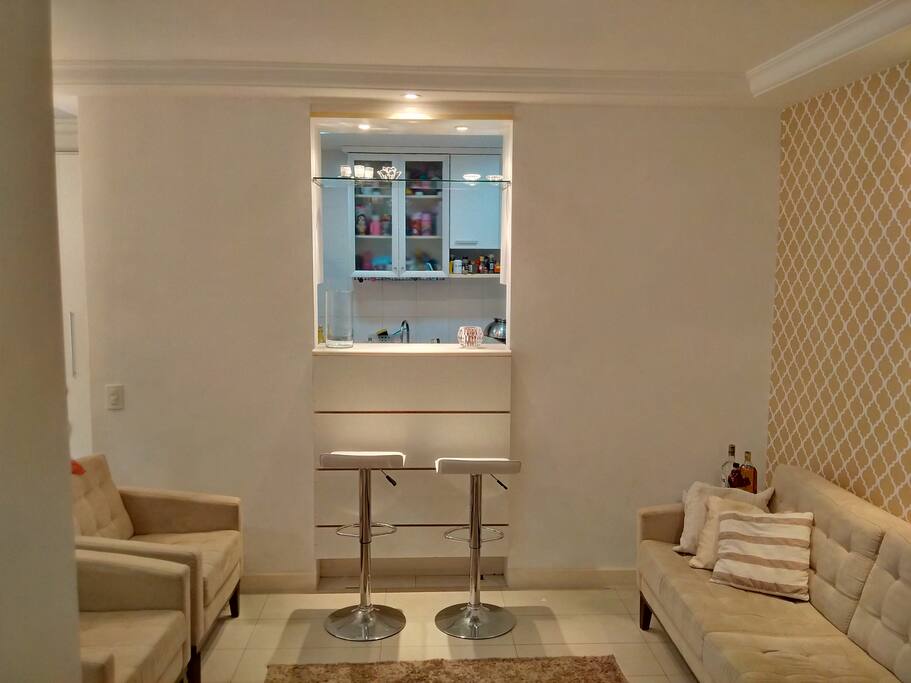 Living room includes sofa, matching chairs and bar stools.