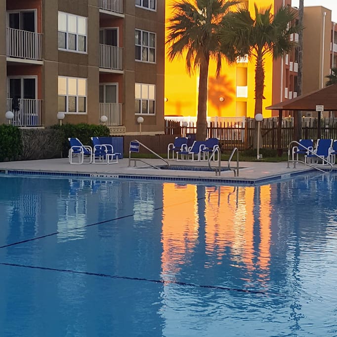 Pool area with clubhouse and outside shower