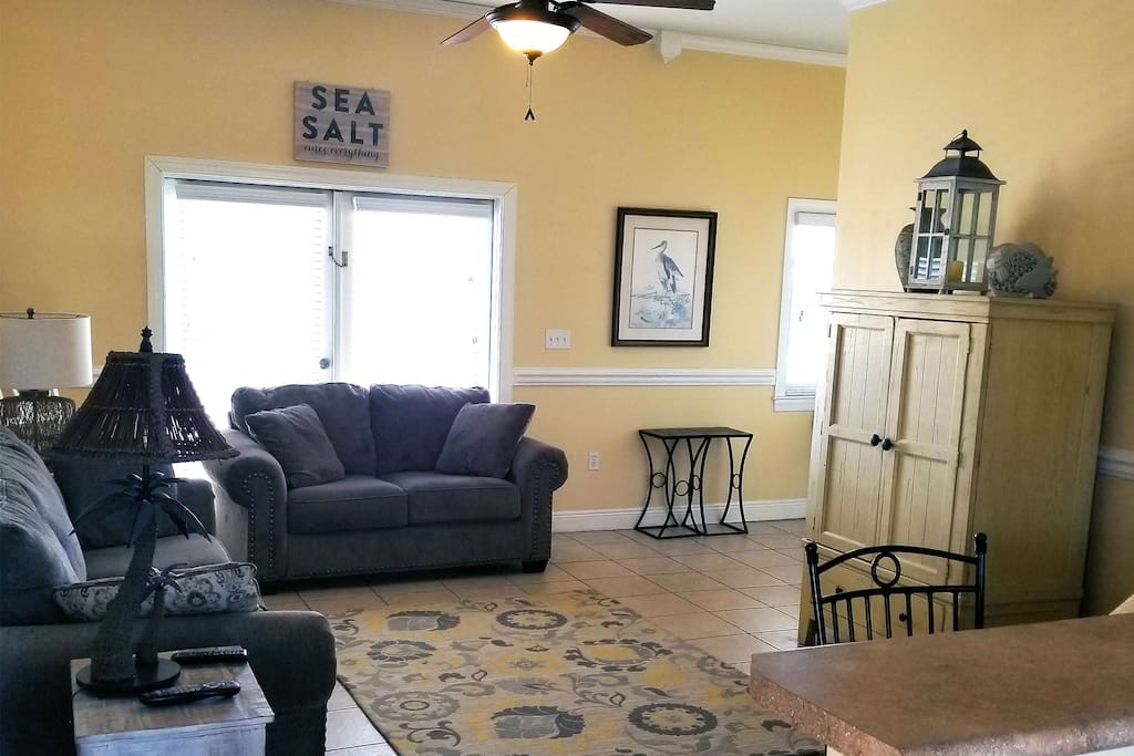 Living area with full sofa and love seat.