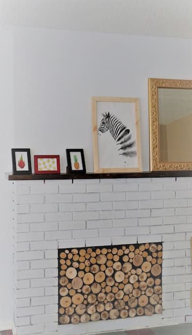 Living Room- I love crafts, you'll see my hand made zebra picture frame and faux-firewood fireplace cover.
