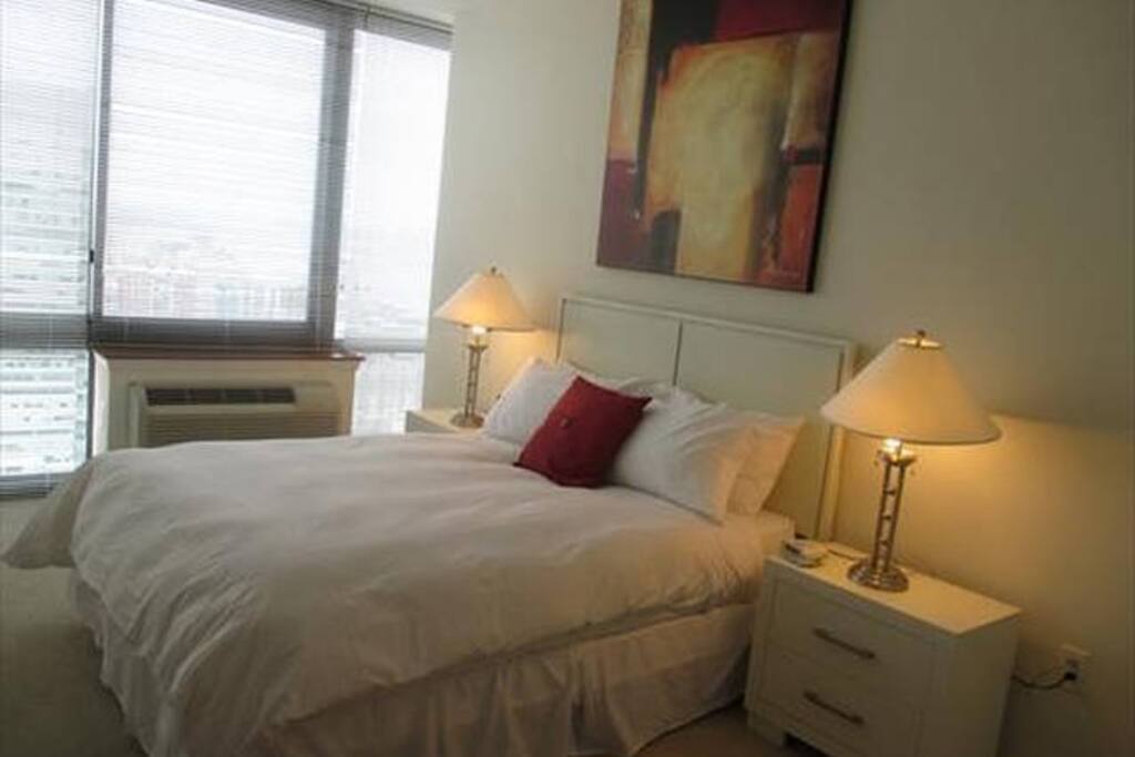 Spacious second bedroom with queen size bed, large closet and floor to ceiling windows providing lovely natural light and amazing views