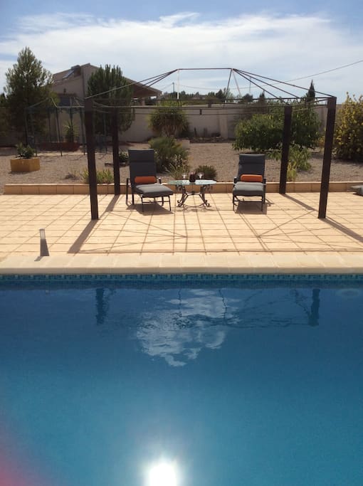 Relax by the pool with a glass of sangria