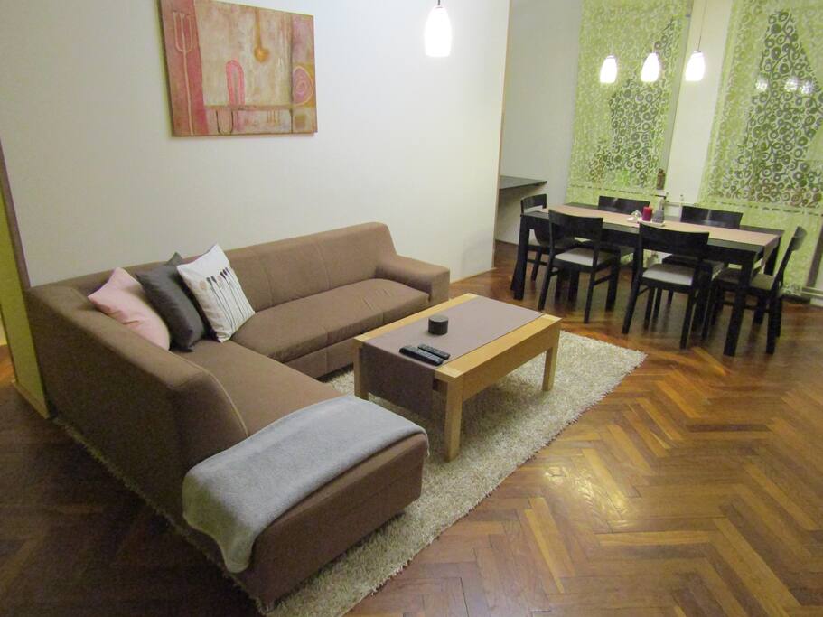 Living room with pull out sofa and big dining table