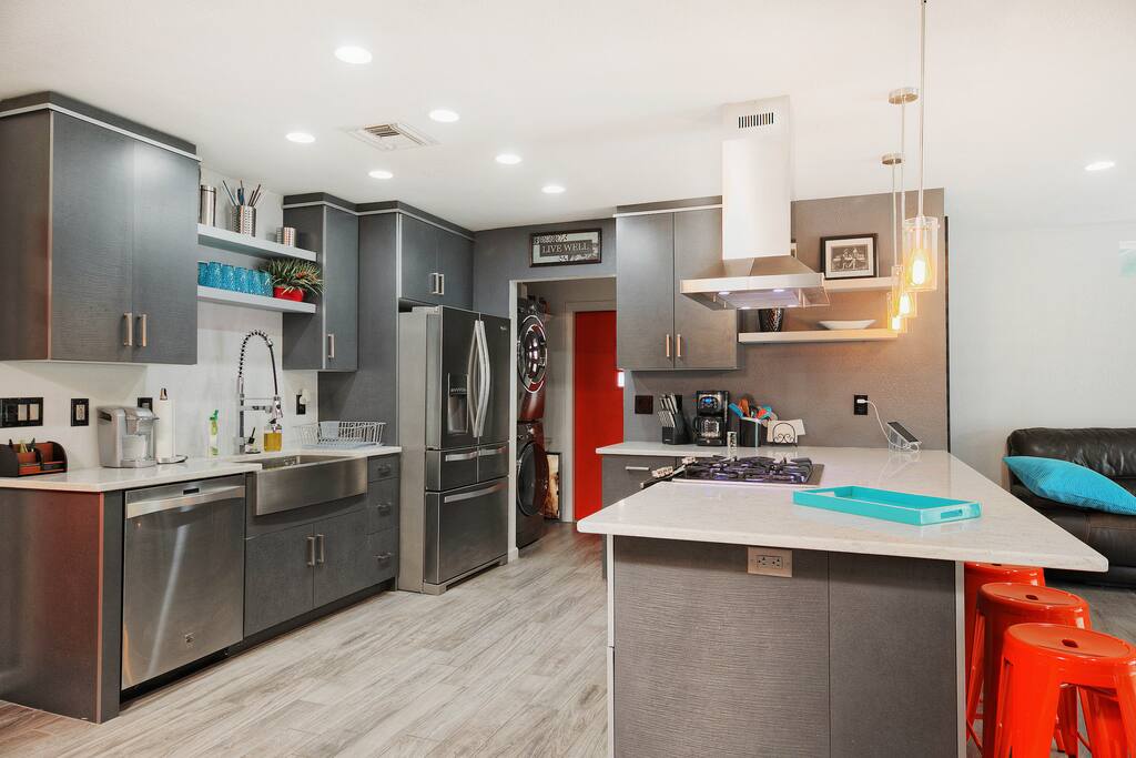 Whip up a feast in the upscale kitchen with stainless steel appliances, open shelving, and an in-island gas range.