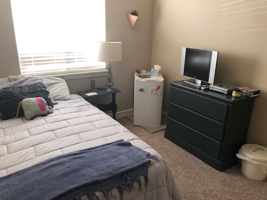 Guest bedroom with mini fridge for your convenience.