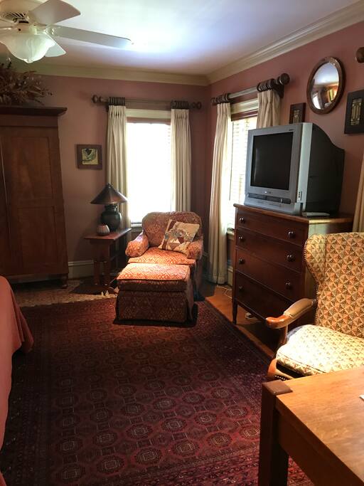Comfortable chair, cable TV, and antique Stickley desk for your use.