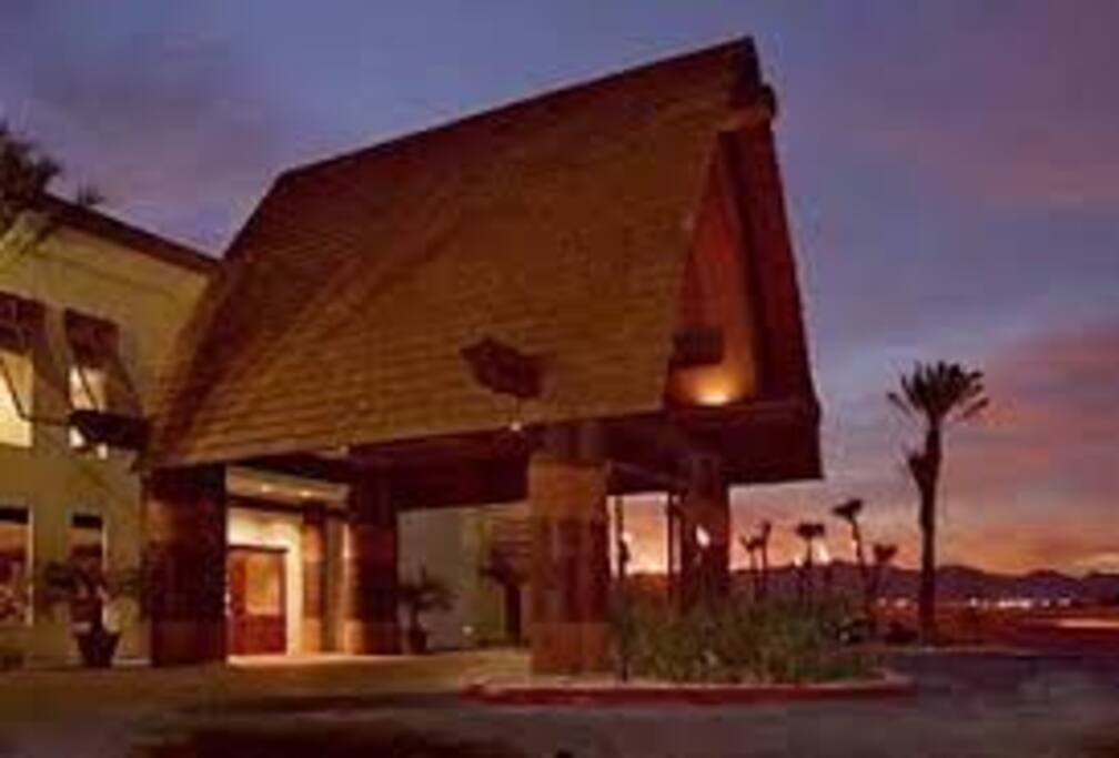 Thatch Porte Cochere, tropical pool cabanas, and tropical landscaping