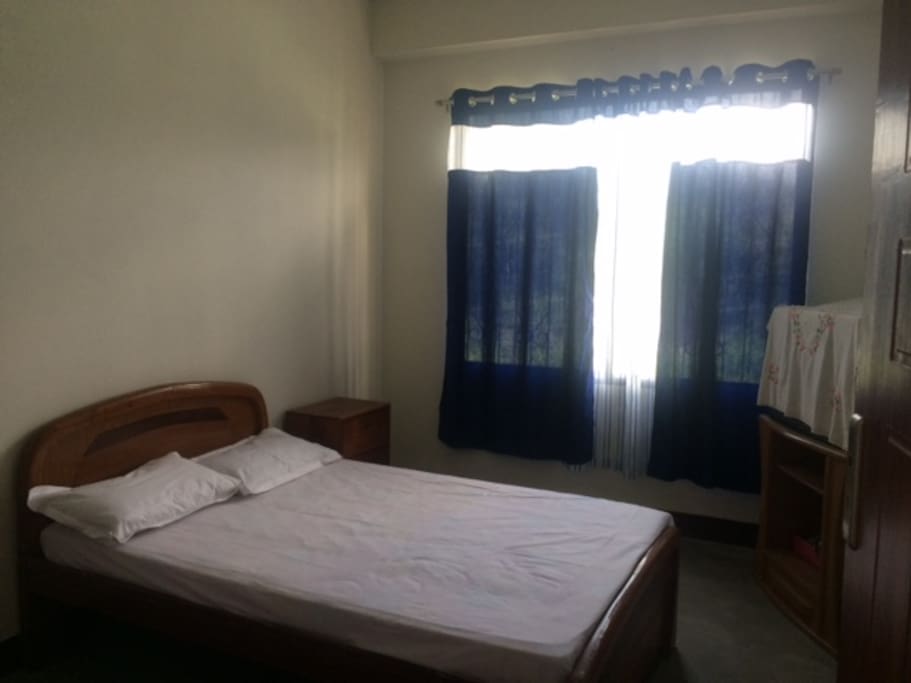 This room has a TV and a closet to keep your belongings.