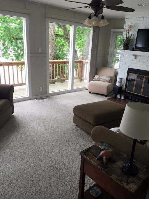 Lots of seating in the living room. TV and DVD player and full wall of windows looking out on the lake.