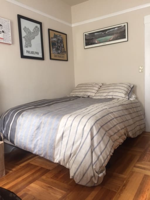 Queen size bed with electronic port for charging phones behind it
