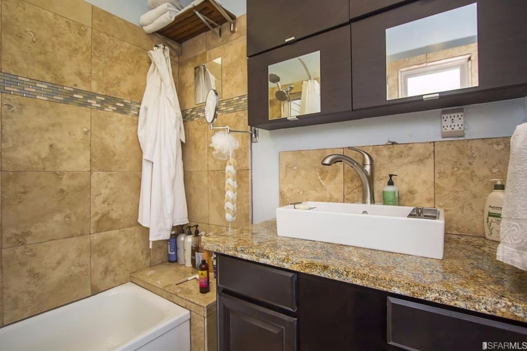 Newly remodeled Travertine and granite bathroom with a double head shower... view the Transamerica building and the bay while showering!