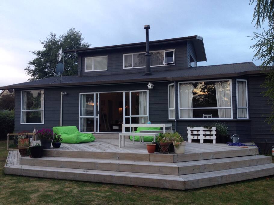 Spacious yard and deck for guests to relax on.