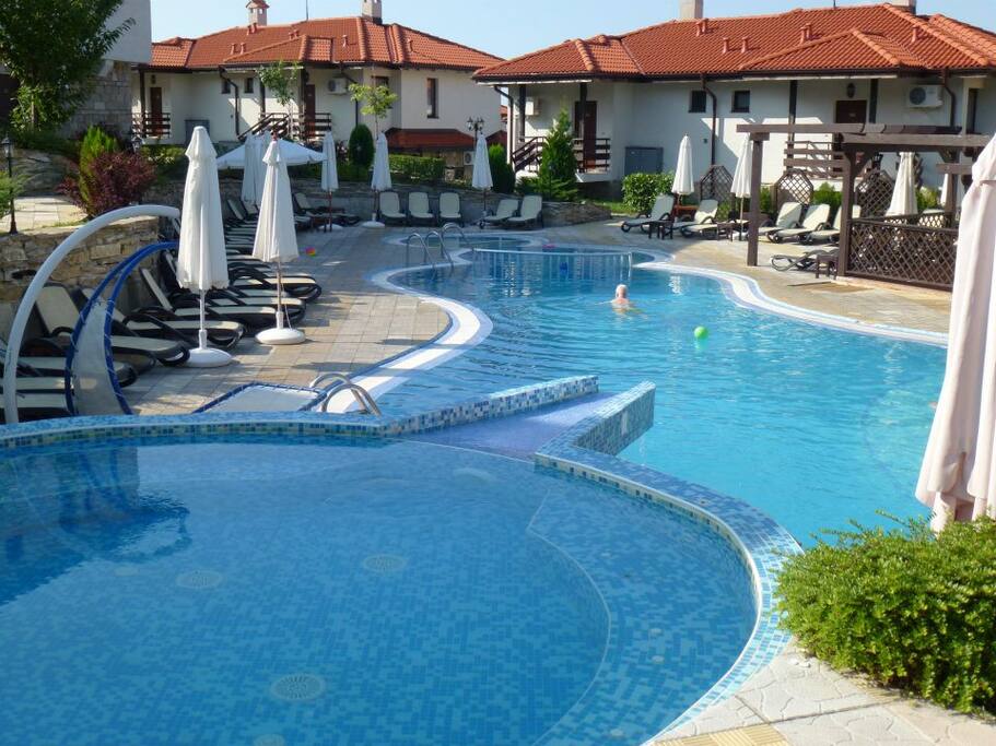 Beautiful sun kissed pool with loungers.