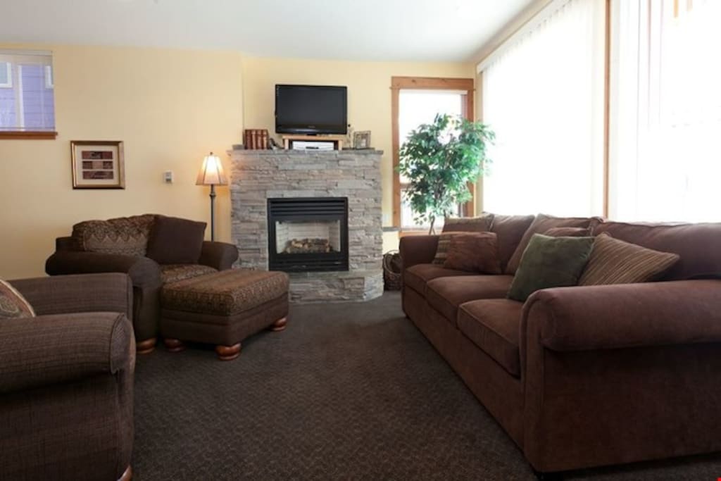 Relax and unwind in the spacious living room with pullout queen sofabed and fireplace.