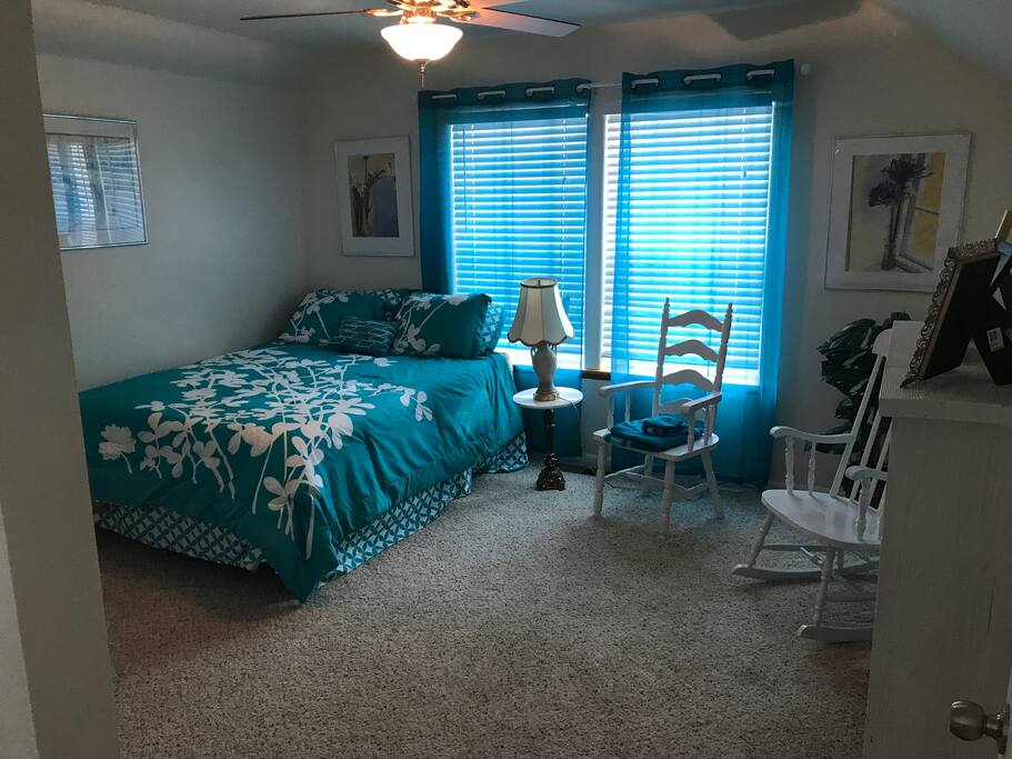 This is our queen room number 2. It is upstairs and provides soft lightening coming from the south. There is closet space, 2 chairs and a bedside table with a lamp ...