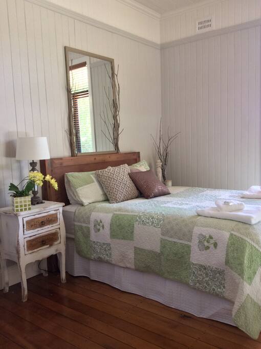 Sunny bedroom with garden views.