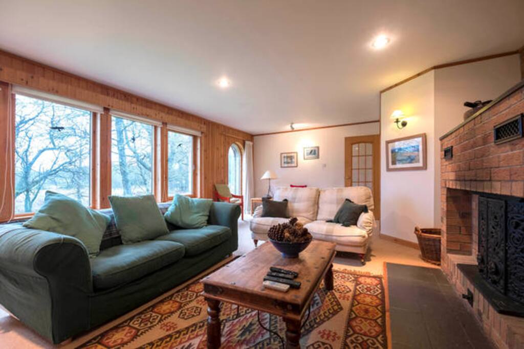 This is the cosy living room with log fire, SKY TV and a lovely view of the garden.