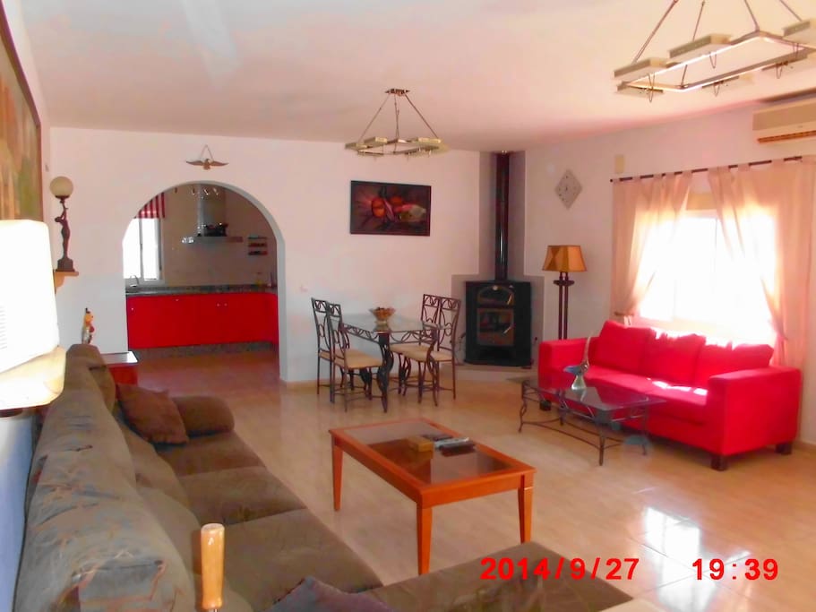 Large Salon with log burner and archway to kitchen