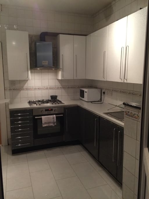 A spacious kitchen with all the basic necessities/supplies to make a proper meal