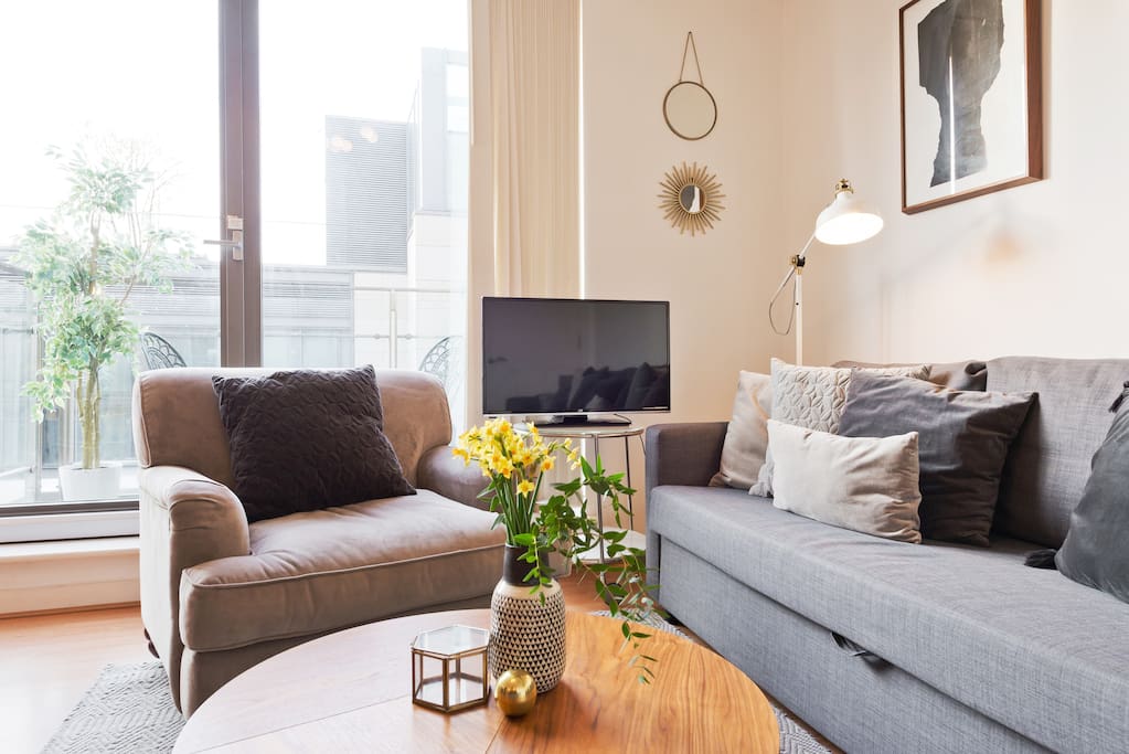 Living area including designer furniture, and balcony view