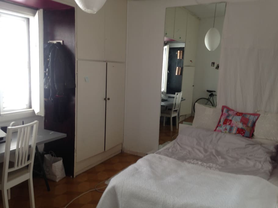 large private room with huge mirror, working desk, queen size bed, commode