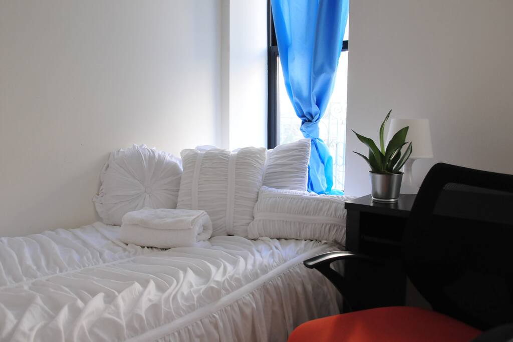 This room gets a lot of light. You'll always have nice bedding welcoming your stay here.