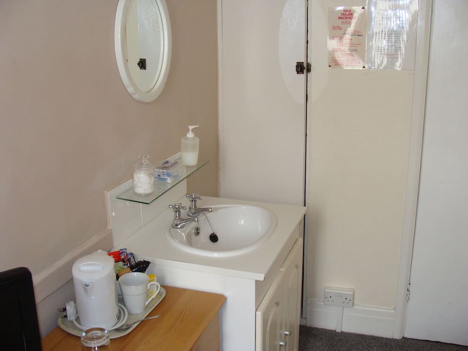 Wash basin and there is a separate but private shower room