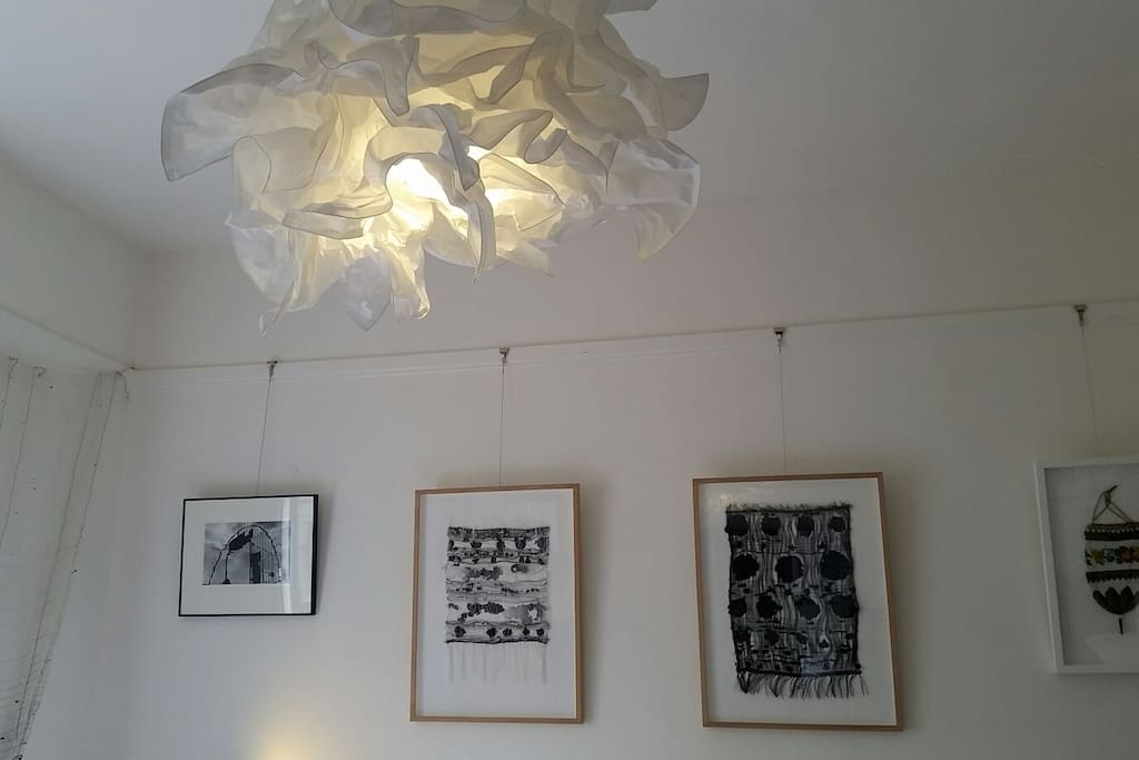 Guest bedroom featuring textile lampshade and textile artworks.