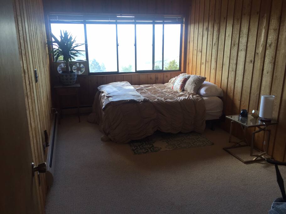 Your room, with a gorgeous view of the mountains, flatirons, and the lights of Denver at night!
