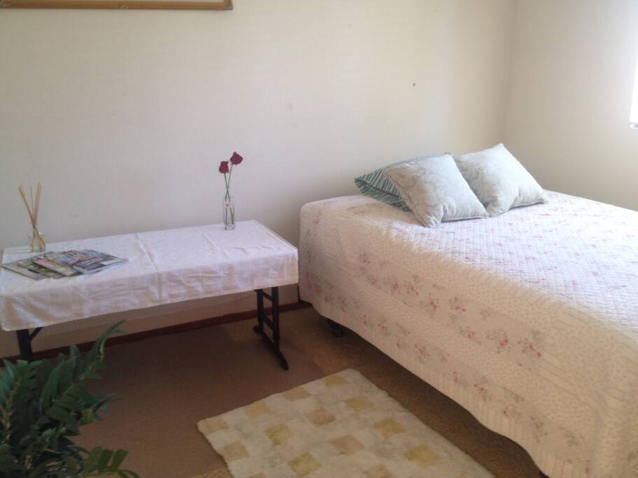 This is a large private room complete with double bed, table and chair, and full bath, vanity & closer.