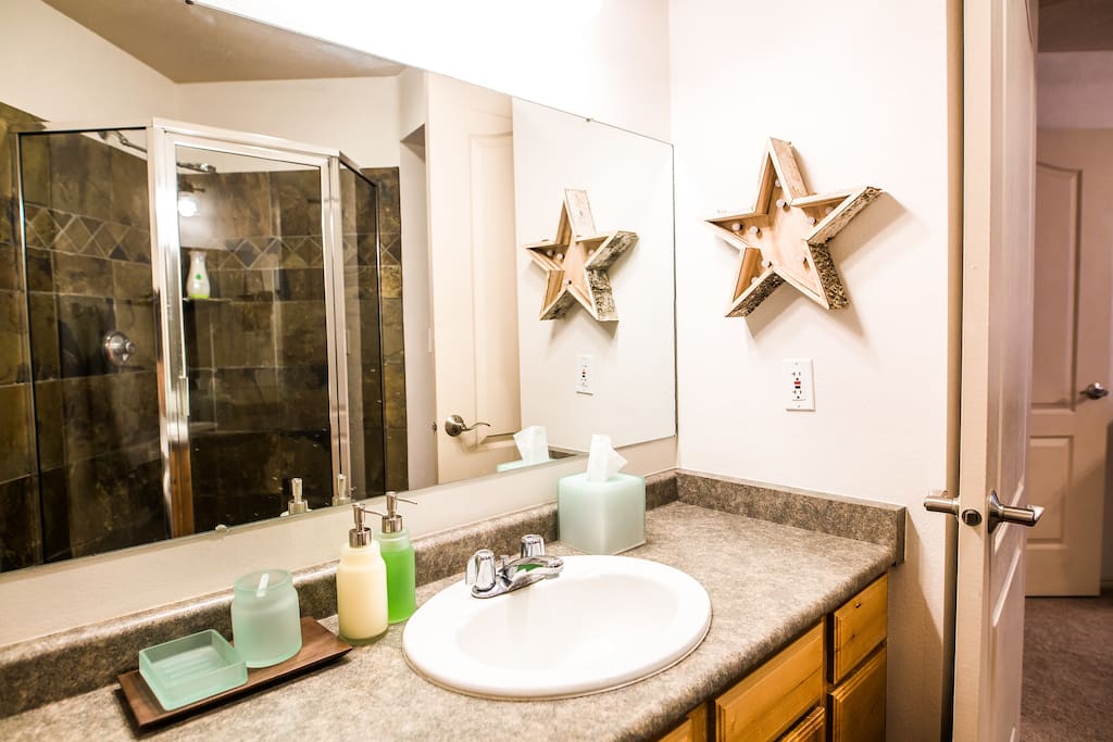 Master bath with shower. Stocked with basic bathroom necessities and plenty of fresh towels.