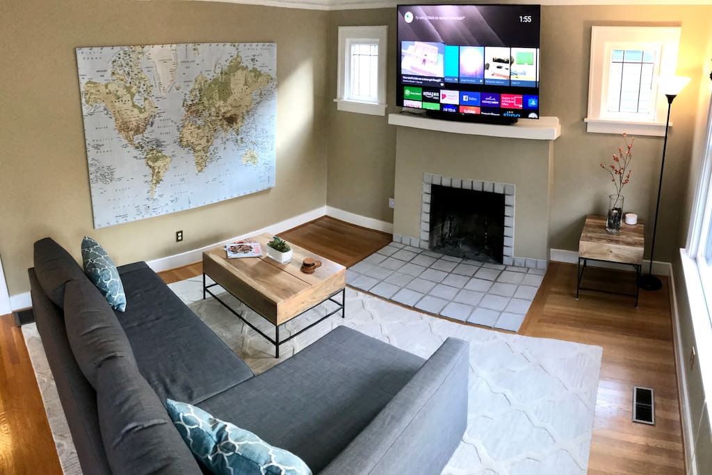 Living room with 65" smart TV, access to Netflix and Hulu. The couch pulls out to become a queen sized sleeper and is very comfortable!